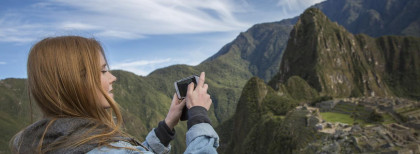 Eine Frau fotografiert die Inka-Ruinen