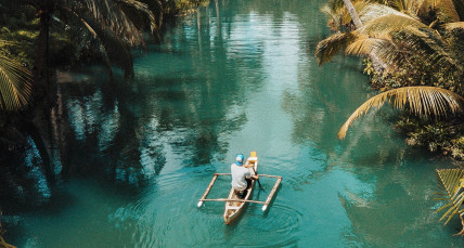 Mann im Kanu auf einem Fluss auf den Philipinnen